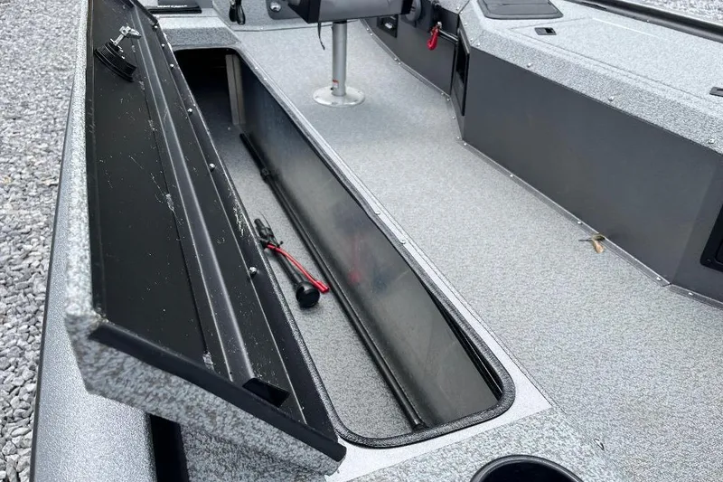 Slide: The Image of 2026 War Eagle 754VS Stick Steer boat interior with open storage compartment. - 10
