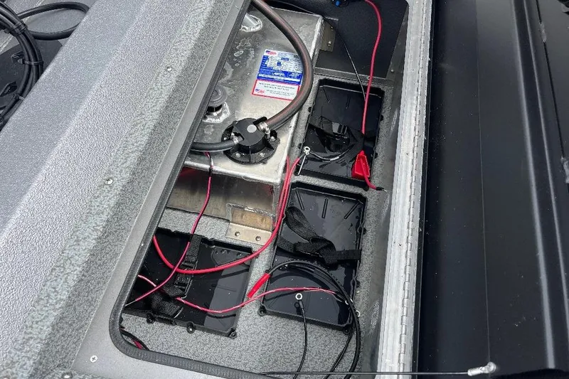 Slide: The Image of Interior view of 2026 War Eagle 754VS Stick Steer boat's battery compartment with wiring. - 11