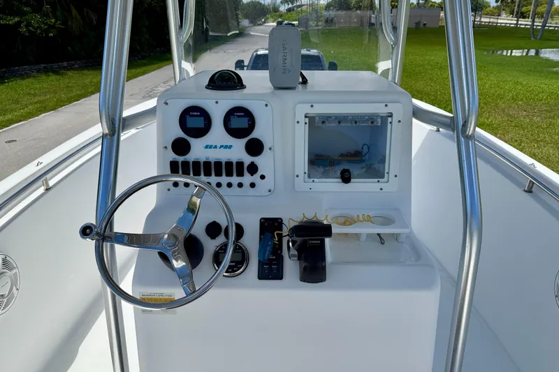 Slide: The Image of 2002 Sea Pro 220 Center Console boat dashboard with steering wheel and controls. - 10