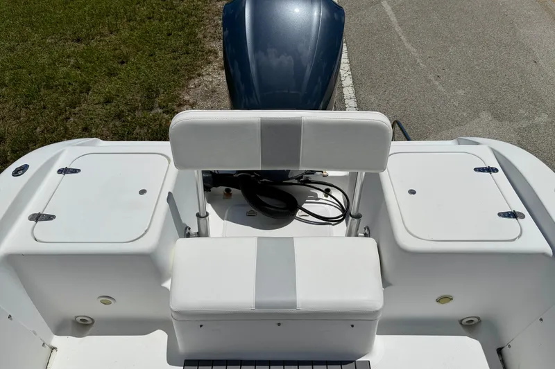 Slide: The Image of 2002 Sea Pro 220 Center Console boat interior with seating and storage compartments. - 16