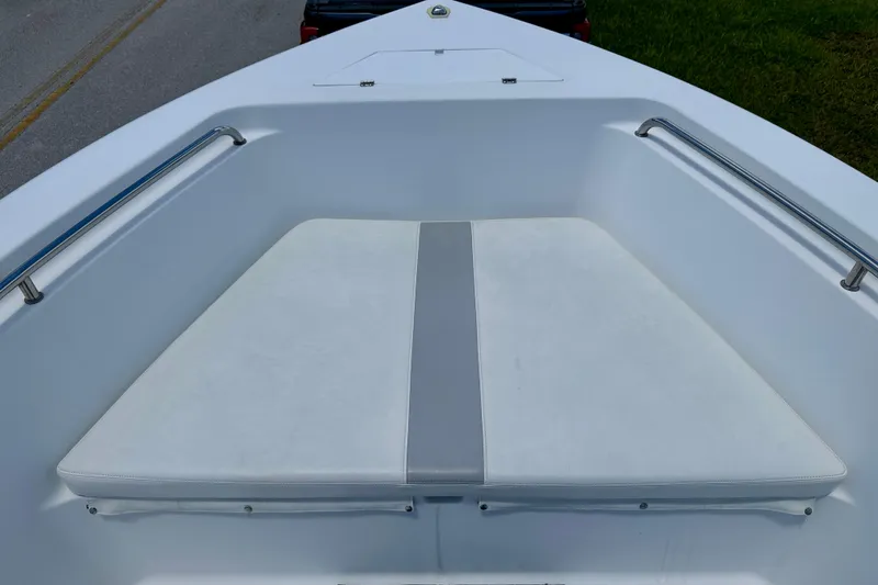 Slide: The Image of 2002 Sea Pro 220 Center Console boat bow seating with white cushions and metal railings. - 18