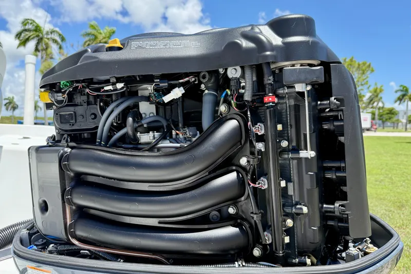 Slide: The Image of Close-up of a 2002 Sea Pro 220 Center Console boat engine under a clear blue sky. - 25