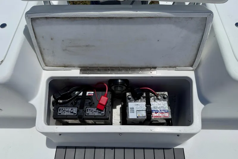 Slide: The Image of Battery compartment of a 2002 Sea Pro 220 Center Console boat, open lid view. - 28