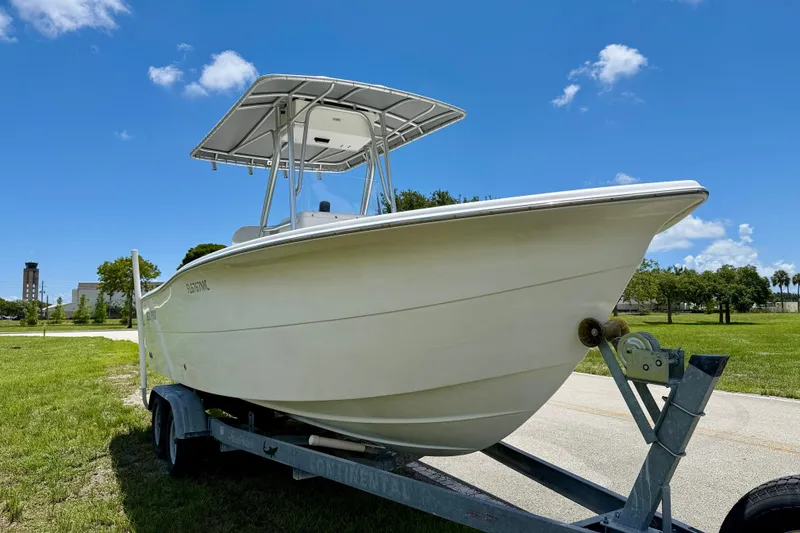 Slide: The Image of 2002 Sea Pro 220 Center Console boat on trailer under clear blue sky. - 3