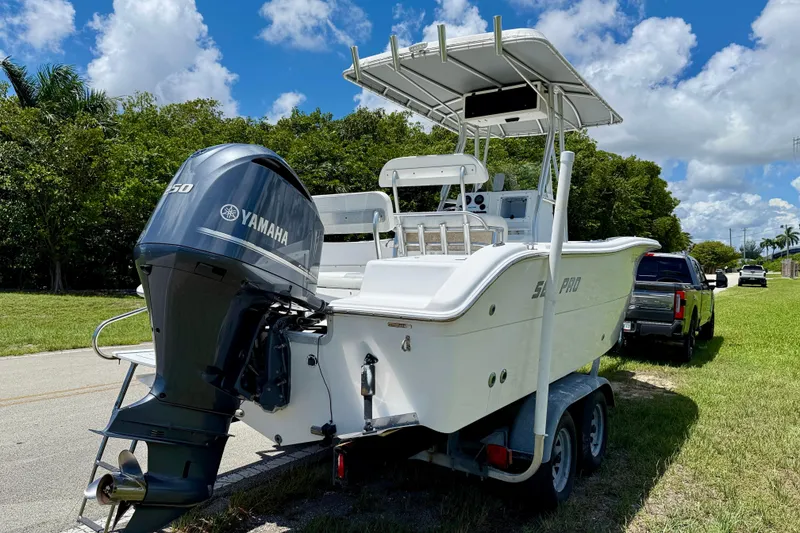 Slide: The Image of 2002 Sea Pro 220 Center Console boat with Yamaha engine on trailer, parked roadside. - 4