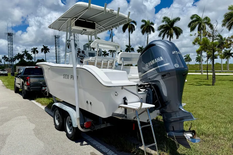 Slide: The Image of 2002 Sea Pro 220 Center Console boat with Yamaha engine on trailer, palm trees in background. - 5