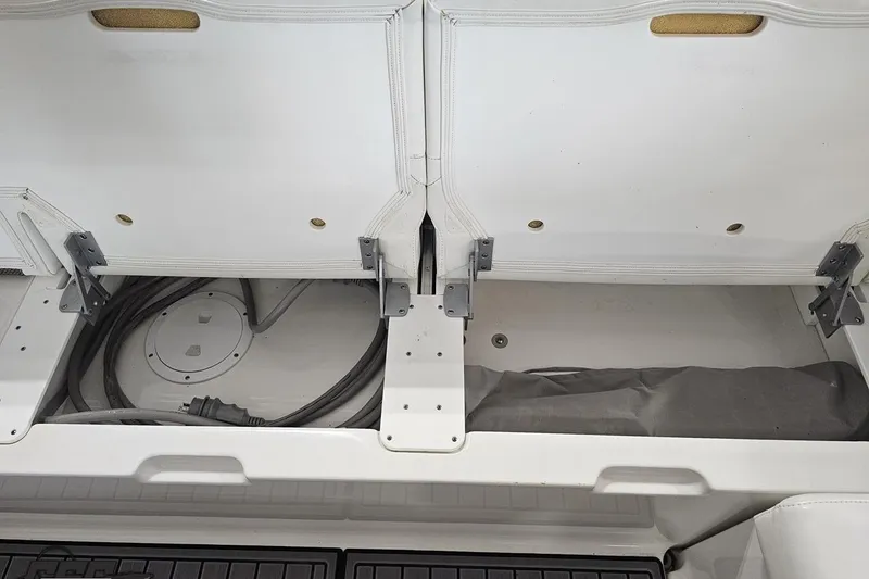 Slide: The Image of 2020 Formula 330 Crossover Bowrider storage compartment with cables and cover. - 107