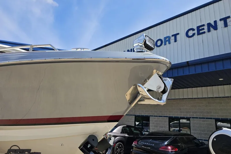 Slide: The Image of 2020 Formula 330 Crossover Bowrider at a marine center, showcasing sleek design and anchor. - 12