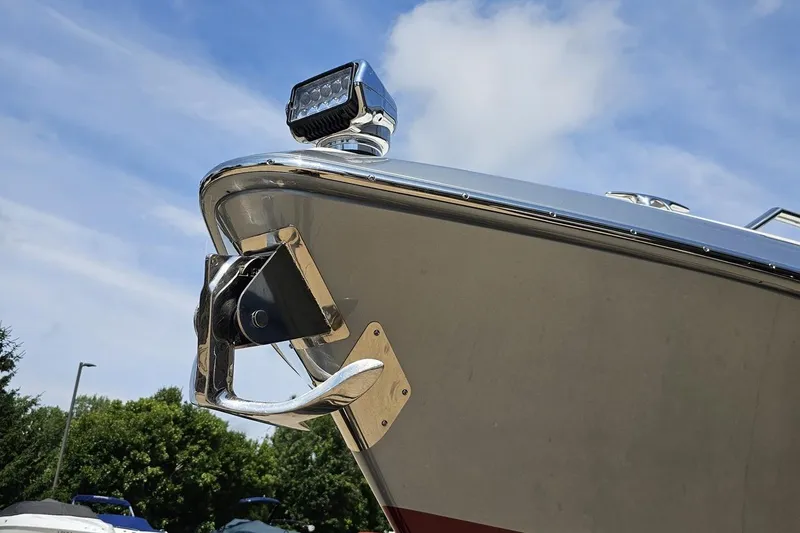 Slide: The Image of 2020 Formula 330 Crossover Bowrider bow with anchor and light under blue sky. - 13