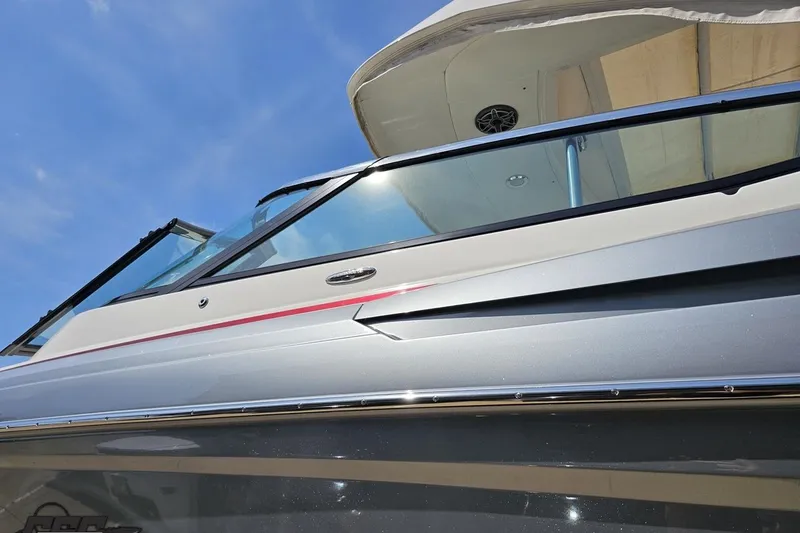 Slide: The Image of 2020 Formula 330 Crossover Bowrider boat, sleek design under clear blue sky. - 23