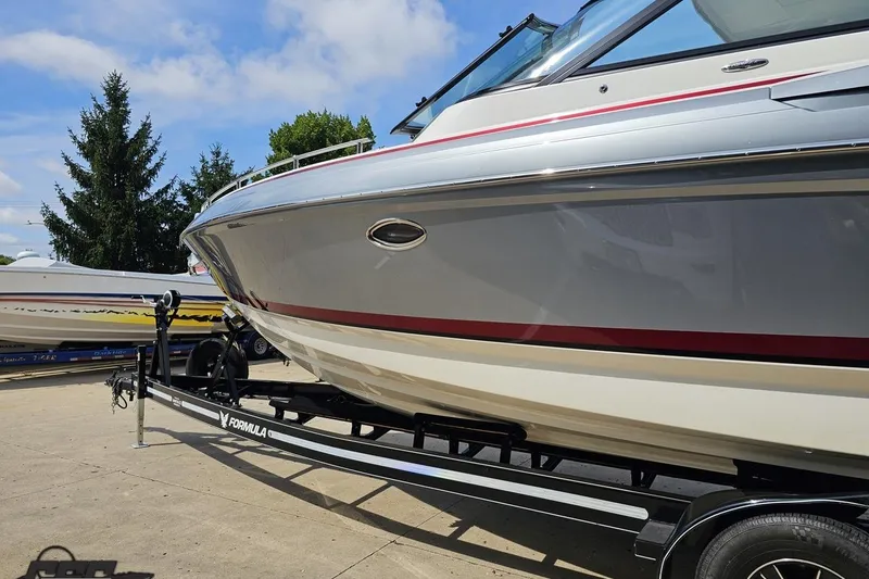 Slide: The Image of 2020 Formula 330 Crossover Bowrider on trailer, sleek design, sunny day. - 25