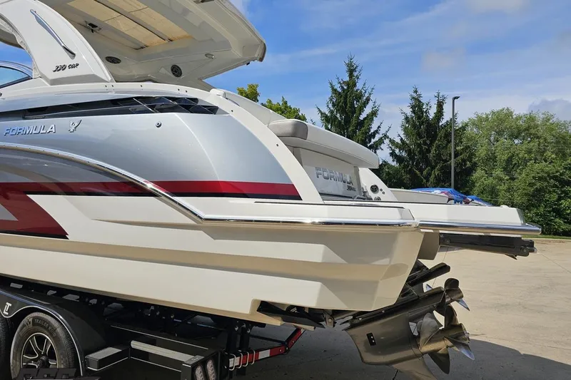 Slide: The Image of 2020 Formula 330 Crossover Bowrider on trailer, showcasing sleek design and powerful engines. - 27