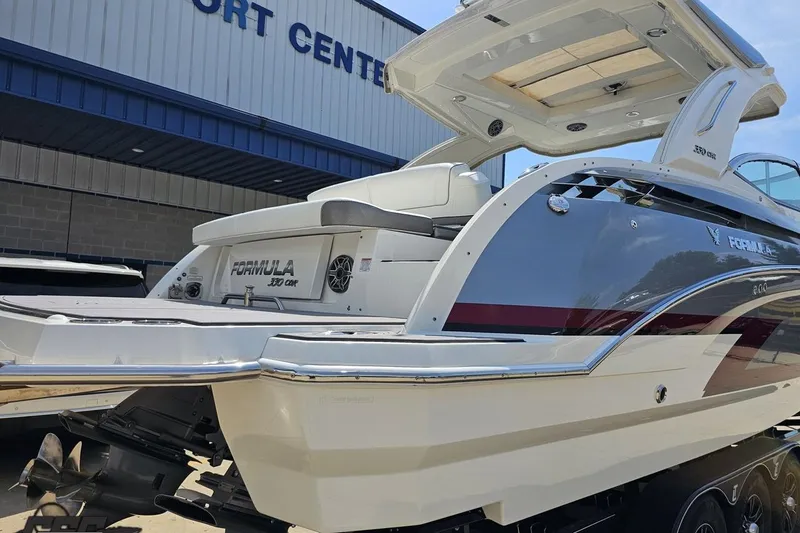 Slide: The Image of 2020 Formula 330 Crossover Bowrider boat at a port center, showcasing sleek design. - 30