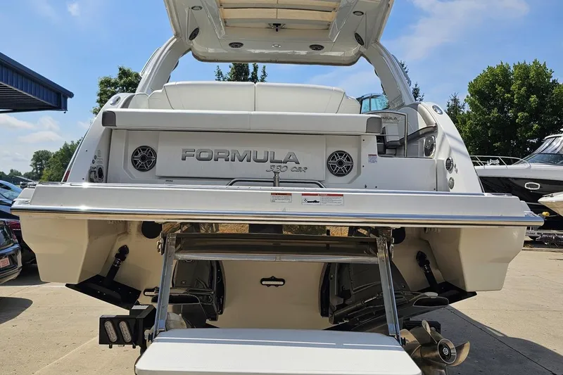 Slide: The Image of 2020 Formula 330 Crossover Bowrider boat rear view with swim platform. - 32