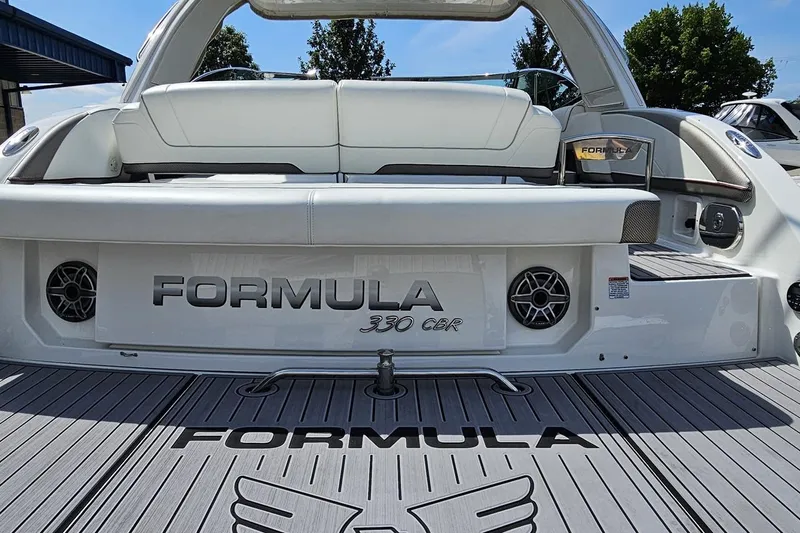 Slide: The Image of 2020 Formula 330 Crossover Bowrider boat, rear view with seating and speakers. - 34