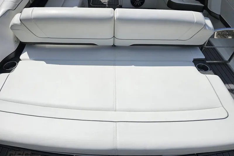 Slide: The Image of 2020 Formula 330 Crossover Bowrider, white seating area with cup holders, luxury boat interior. - 37