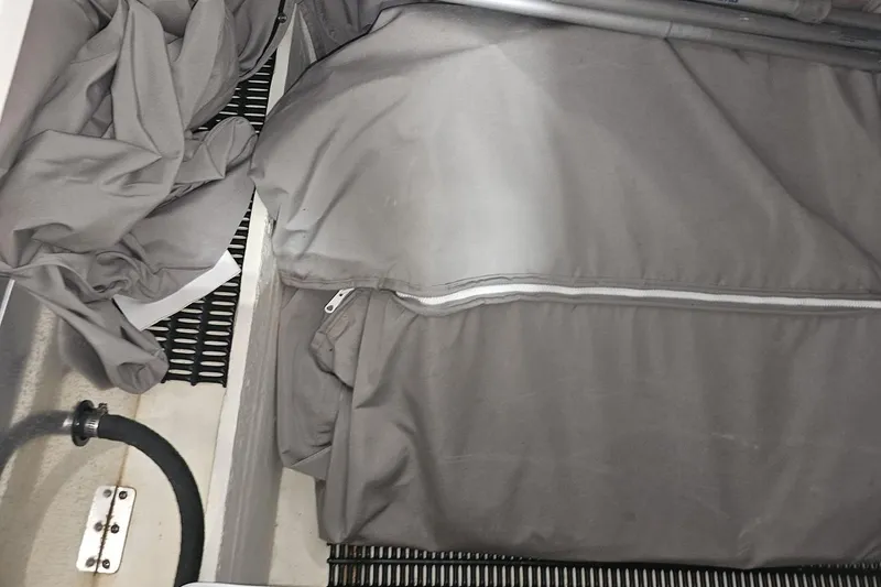 Slide: The Image of Storage compartment of a 2020 Formula 330 Crossover Bowrider with gray fabric covers. - 60