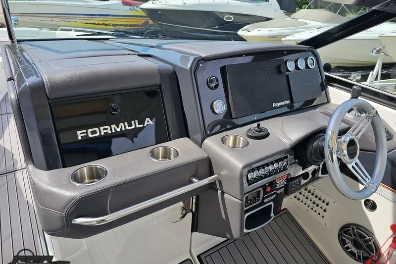 Slide: The Image of 2020 Formula 330 Crossover Bowrider dashboard with steering wheel and navigation controls. - 62