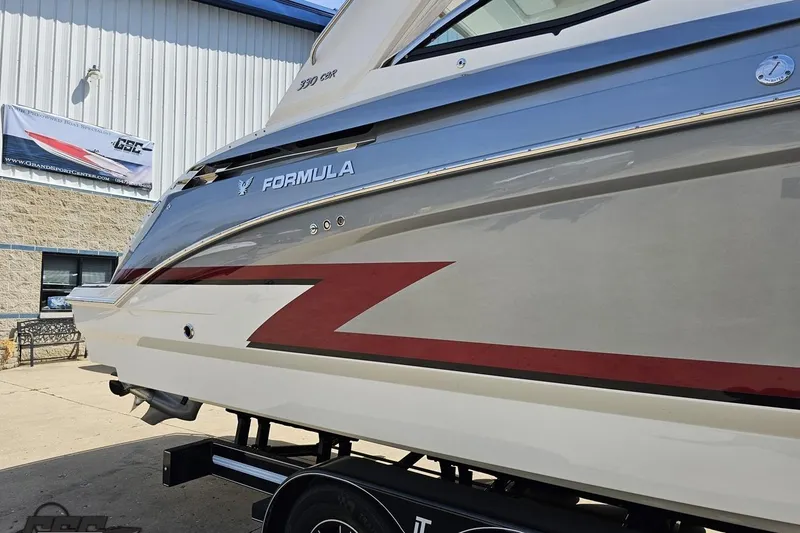 Slide: The Image of 2020 Formula 330 Crossover Bowrider boat displayed outdoors, showcasing sleek design and branding. - 7