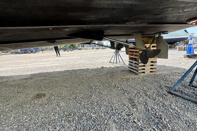 Slide: The Image of 2004 Carver 360 Mariner propeller and hull on dry dock, gravel surface. - 11