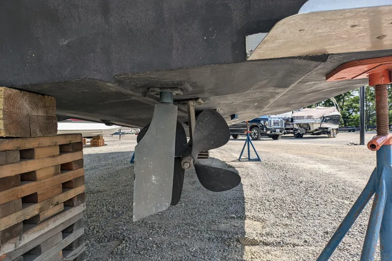 Slide: The Image of 2004 Carver 360 Mariner propeller and rudder on dry dock, supported by wooden blocks. - 14