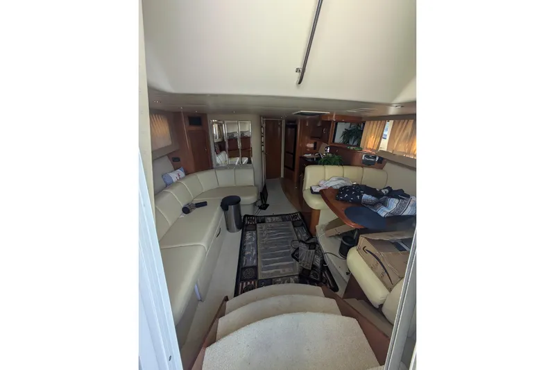 Slide: The Image of Interior of 2004 Carver 360 Mariner yacht with beige seating and wooden accents. - 15