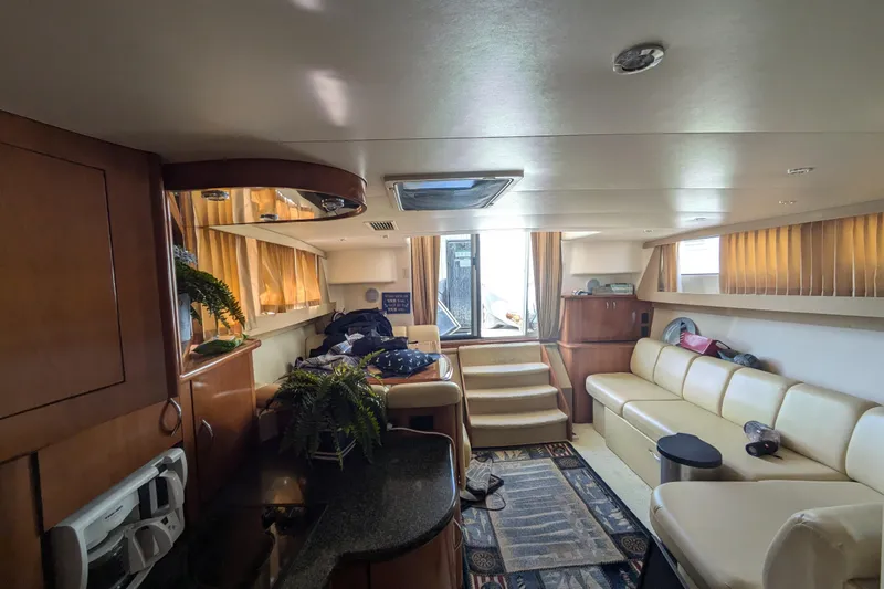 Slide: The Image of Interior of 2004 Carver 360 Mariner yacht with beige seating and wooden cabinetry. - 17