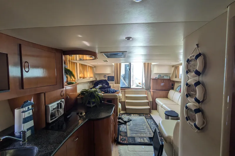 Slide: The Image of Interior of 2004 Carver 360 Mariner yacht with modern kitchen and cozy seating area. - 20