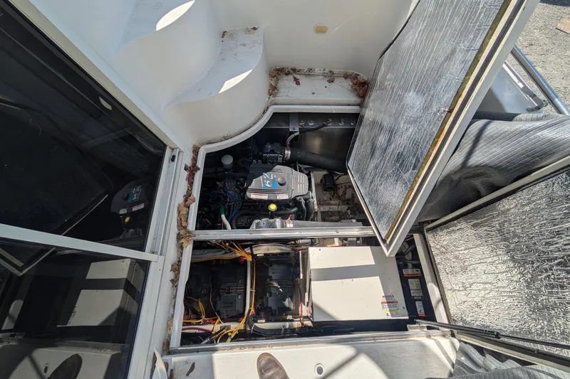 Slide: The Image of Engine compartment of a 2004 Carver 360 Mariner boat, showing mechanical components. - 23