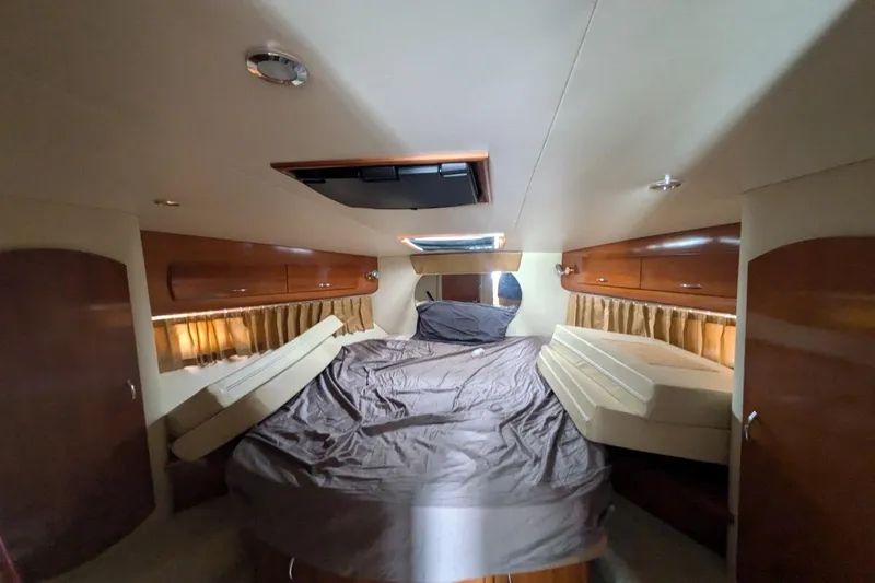 Slide: The Image of 2004 Carver 360 Mariner boat on dry dock, with anchor, against blue sky backdrop. - 3