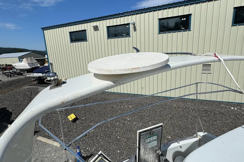 Slide: The Image of 2004 Carver 360 Mariner boat detail with radar arch, docked near a building. - 30