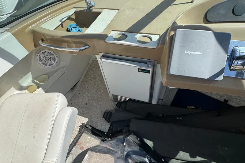 Slide: The Image of 2004 Carver 360 Mariner cockpit with Raymarine equipment and compact refrigerator. - 37