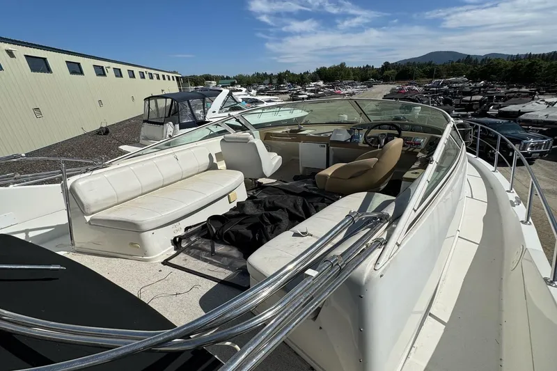 Slide: The Image of 2004 Carver 360 Mariner yacht on dry dock, surrounded by other boats, under clear blue sky. - 4