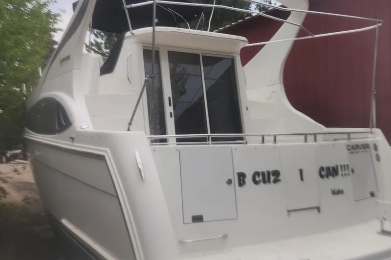 Slide: The Image of 2004 Carver 360 Mariner yacht docked near a red building. - 45