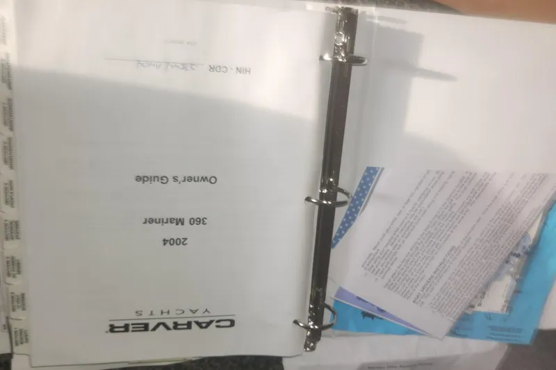 Slide: The Image of Owner's guide for 2004 Carver 360 Mariner in a binder, partially open. - 47