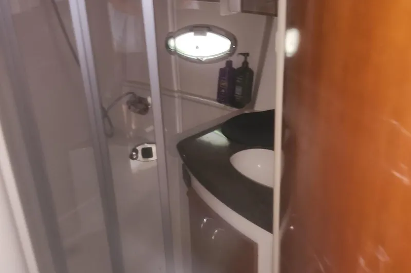 Slide: The Image of 2004 Carver 360 Mariner bathroom with shower, sink, and toiletries. - 49