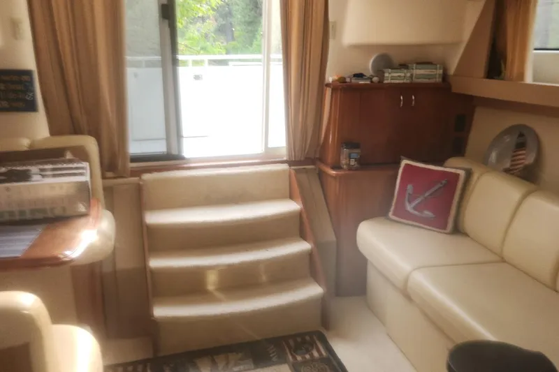 Slide: The Image of Interior of 2004 Carver 360 Mariner yacht with beige seating and wooden cabinetry. - 56