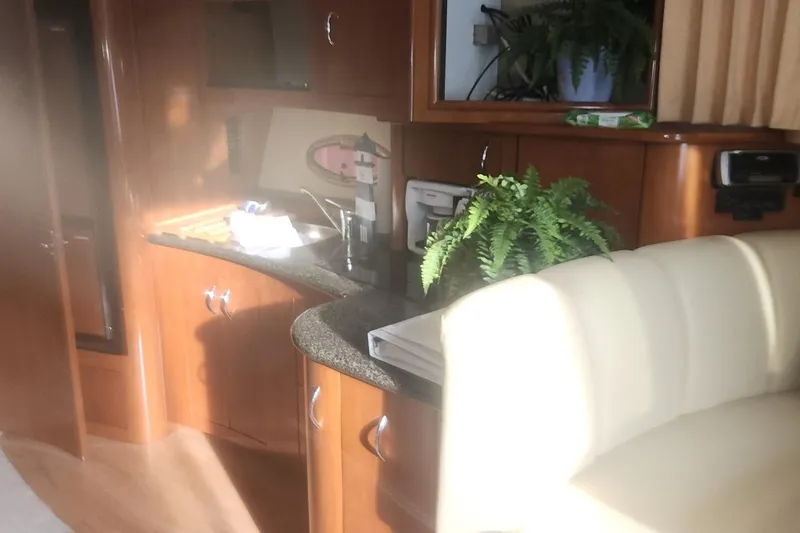 Slide: The Image of Interior of 2004 Carver 360 Mariner yacht with wooden cabinetry and a potted fern. - 57