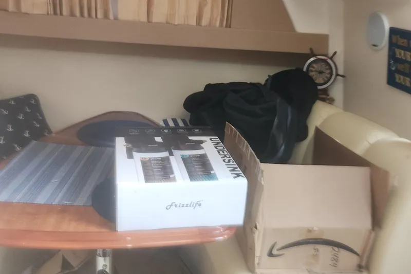 Slide: The Image of Interior of 2004 Carver 360 Mariner with boxes on a table. - 58