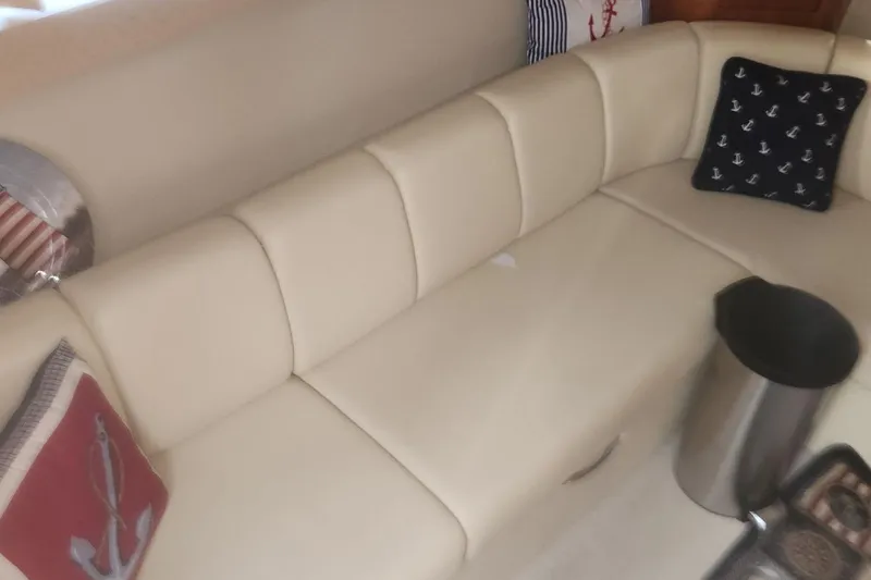 Slide: The Image of Cream leather seating with nautical-themed pillows on a 2004 Carver 360 Mariner yacht. - 60