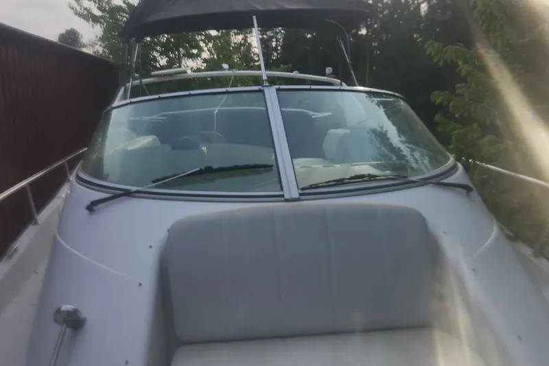 Slide: The Image of 2004 Carver 360 Mariner boat with windshield and seating, surrounded by trees. - 63