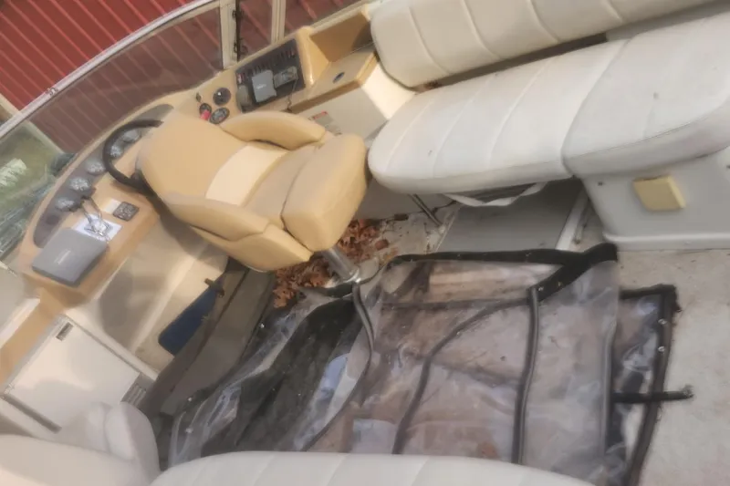 Slide: The Image of 2004 Carver 360 Mariner interior with beige seating and steering console. - 64