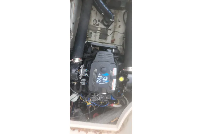 Slide: The Image of Engine compartment of a 2004 Carver 360 Mariner boat, featuring a 7.9L engine. - 66
