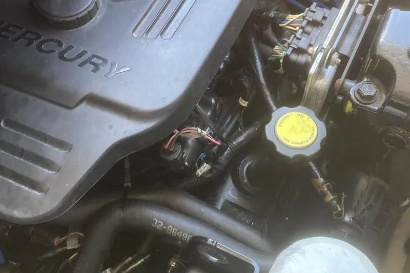 Slide: The Image of Engine compartment of a 2007 Sea Ray 195 Sport boat, featuring Mercury components. - 13