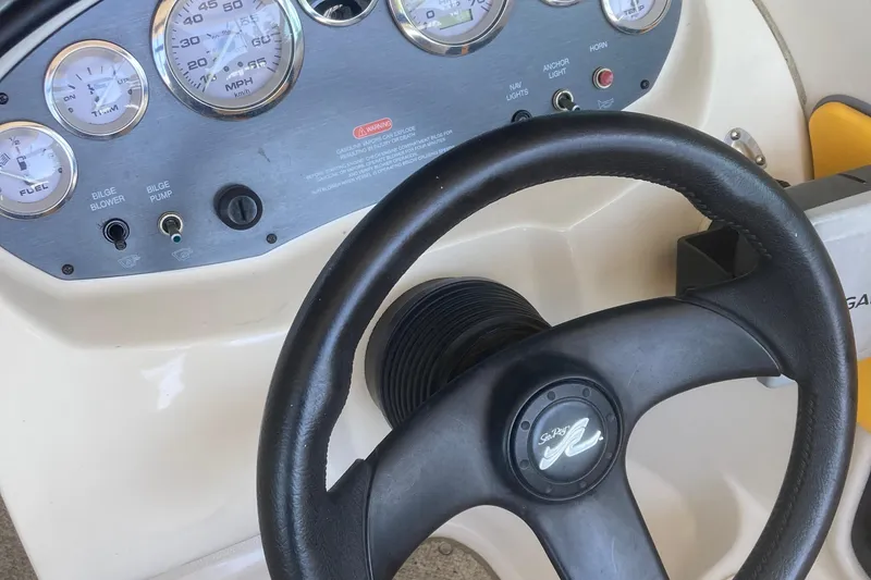 Slide: The Image of 2007 Sea Ray 195 Sport dashboard with steering wheel and instrument panel. - 14