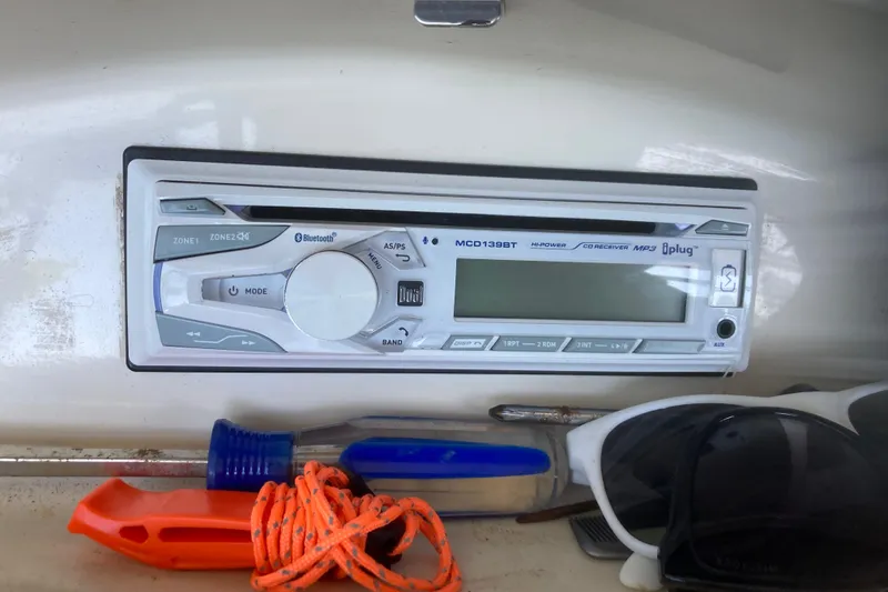 Slide: The Image of Boat stereo system on 2007 Sea Ray 195 Sport with accessories nearby. - 15