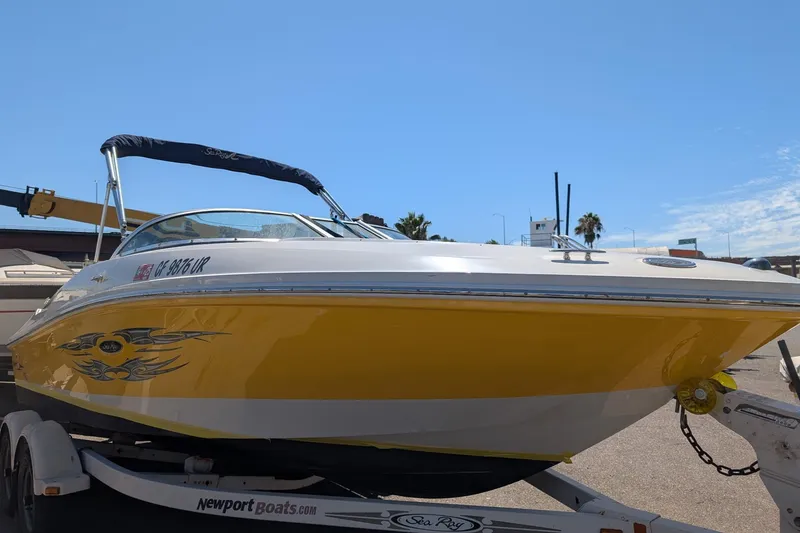 Slide: The Image of 2007 Sea Ray 195 Sport boat with yellow hull on trailer, sunny day. - 3