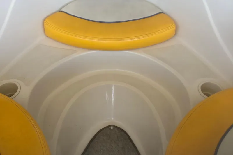 Slide: The Image of 2007 Sea Ray 195 Sport boat interior with yellow seating and cup holders. - 9