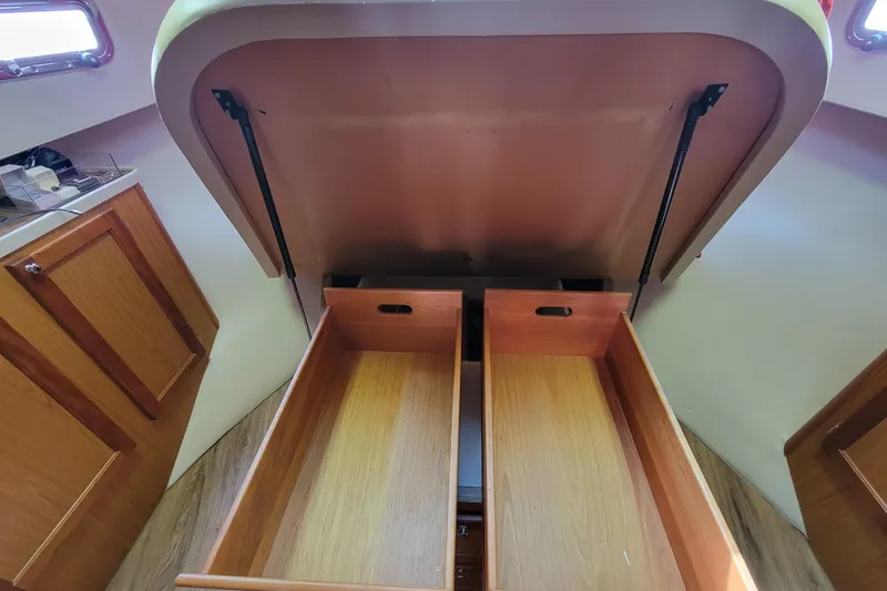 Slide: The Image of Open storage drawers inside a 2006 Mainship 40 Trawler boat interior. - 101