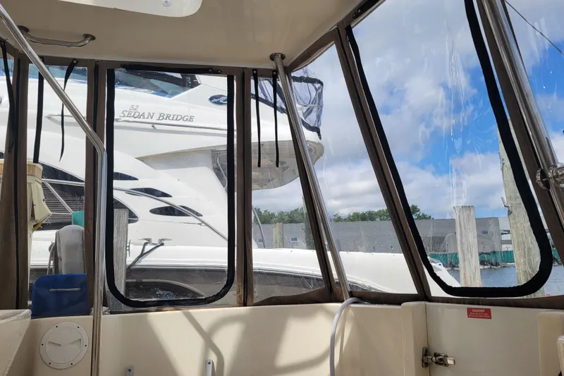 Slide: The Image of 2006 Mainship 40 Trawler interior view with docked boats outside. - 104